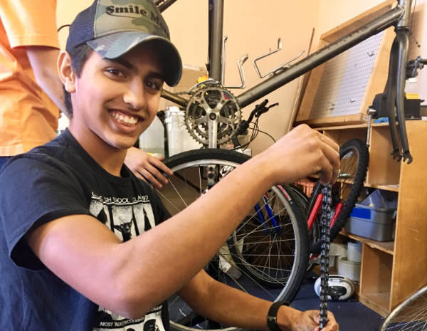 Young man cleaning a chain