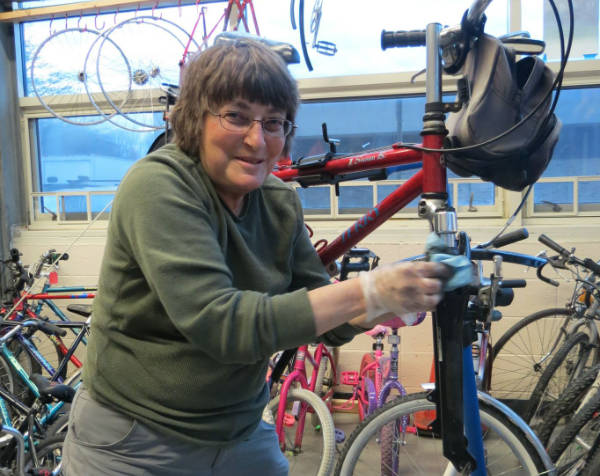 Women working on a bike at women's class