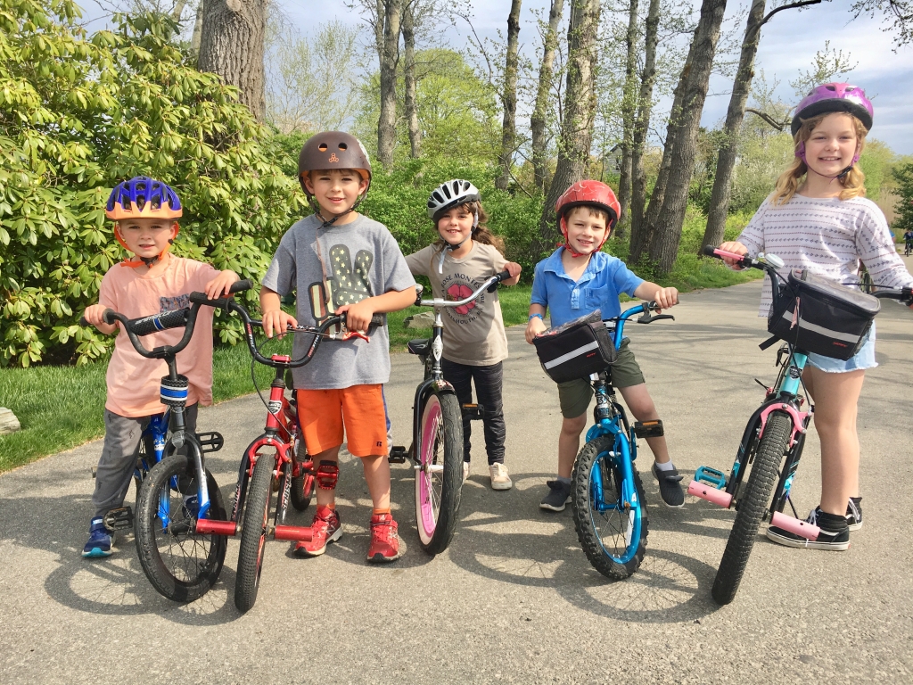 Five young white kids standing with their bicycles