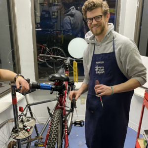Three Bike Garage mechanics smiling in the shop