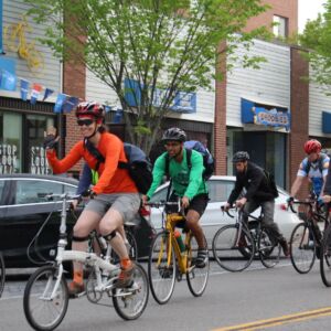 Several bike commuters riding to work past Bike Newport headquarters