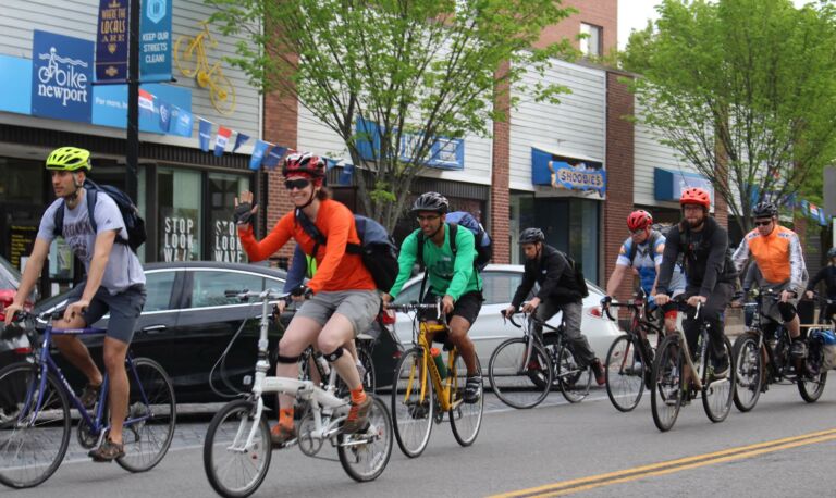 Several bike commuters riding to work past Bike Newport headquarters