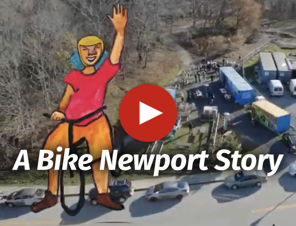 Video thumbnail showing arial view of Bike Barn campus with text A Bike Newport Story