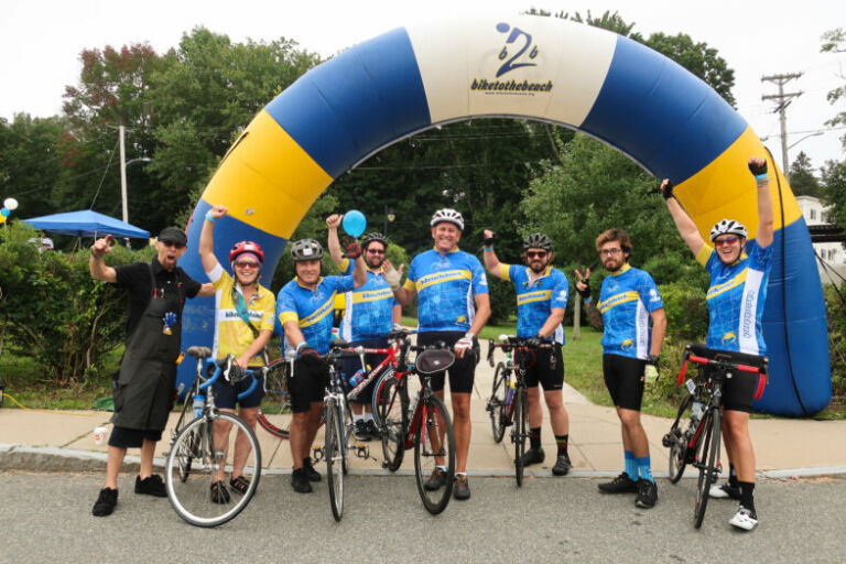 Bike Newport team in their kits at the Bike to the Beach finish