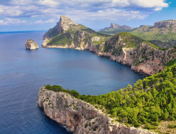 wide shot of famous Mallorcan rocky peak descending to the sea