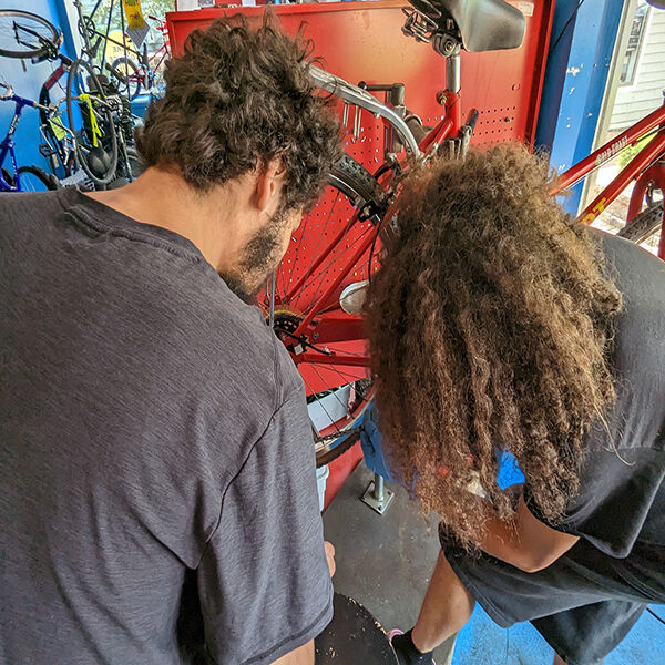 Austin and Julien working on a bicycle