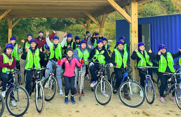 Group portrait of participants in Rogers Ciclistas in their new bikes