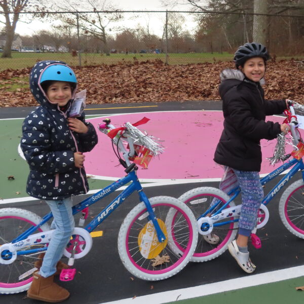 children on bikes at the holidday bike giveaway