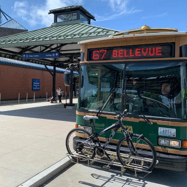 Green Newport Trolley bus with a bicycle on its front rack