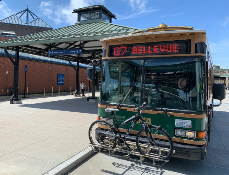 Green Newport Trolley bus with a bicycle on its front rack