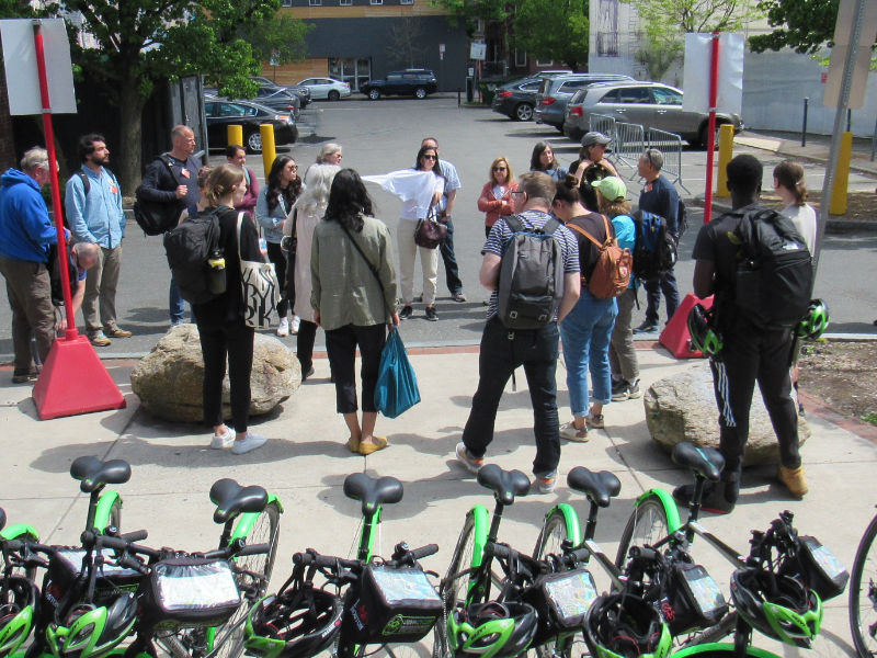 Several people facing the ride leader with bikes in the foreground