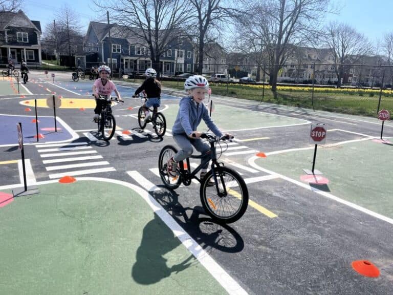 Children cycling on a bike safety training course at Bike Newport, promoting bike safety and skills for youth cyclists.