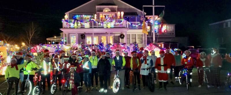 Festive Christmas bike ride with decorated bikes, Santa costumes, and holiday lights in Newport, RI - Bike Newport community event.