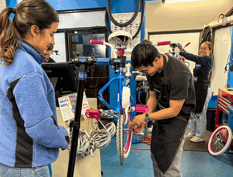 Bike repair workshop with students assembling bicycles at Bike Newport, Rhode Island, community cycling event, emphasizing bike maintenance, safety, and local bike culture in Newport.