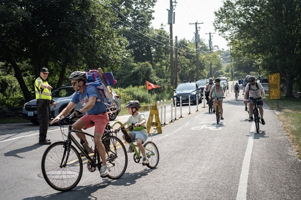 Cyclist towing child using the bike lane