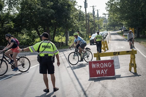 Police officer directs traffic for cyclists