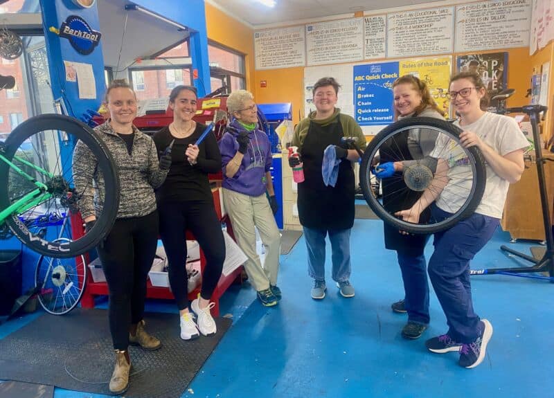 Bike repair workshop at Bike Newport, community bike shop with bicycle maintenance and repair classes, friendly staff, and cycling safety education.