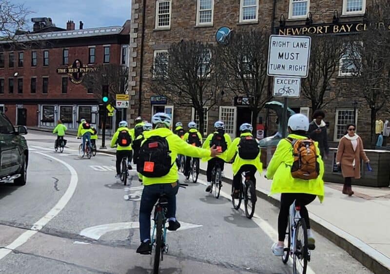 Diverse group of cyclists riding together in Newport, emphasizing inclusivity and community engagement in cycling advocacy.
