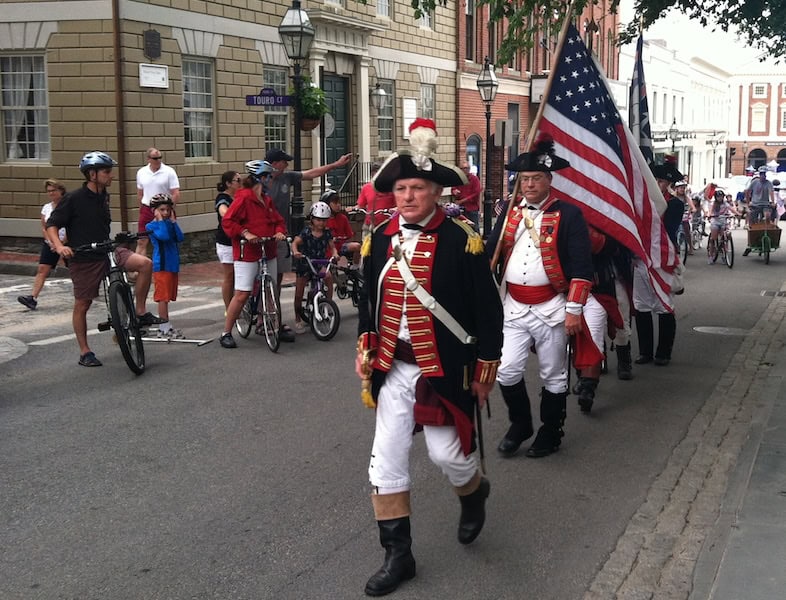 Spectators enjoying the 4th of July Parade by bike