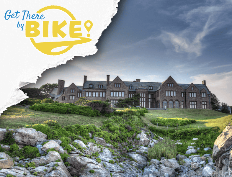 A large historic mansion on a hill with green lawns and rocks in the foreground, under a partly cloudy sky, with a logo in the top left corner reading 'Get There by Bike!'.