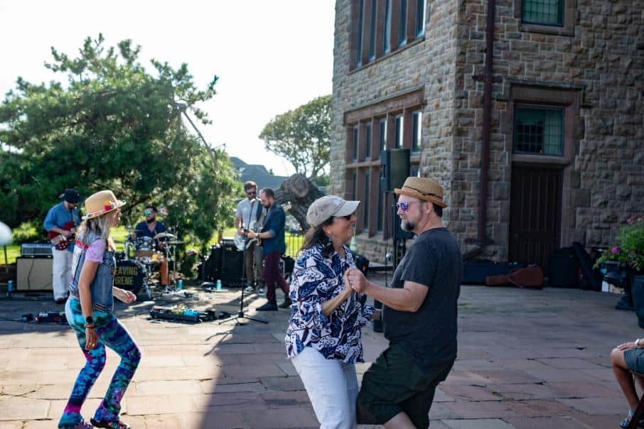 A couple dances on a stone terrace in front of the band Leaving Irene.